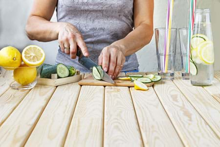 woman preparing lemon alkaline drink