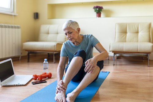 Woman Touching Hurt Ankle