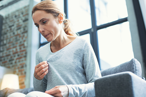 A woman having a hot flash is looking for natural options for relief