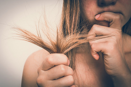 A woman in need of a DIY winter hair oil treatment