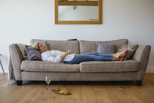 Woman putting her bones in danger from being inactive on the couch. 