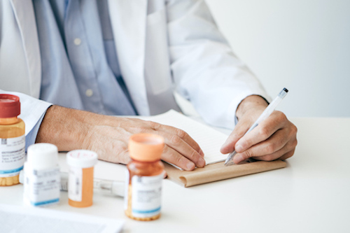 Doctor writing a prescription for bone health 