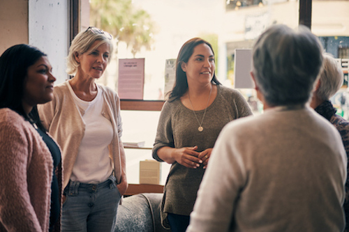 Group of women discussing bone health risk factors.