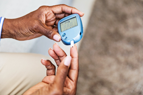 Woman testing her blood glucose level with diabetes. 