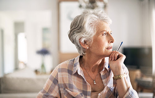 Woman thinking about the difference osteoporosis and osteopenia