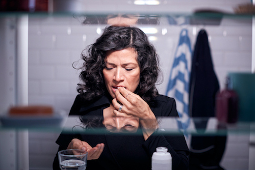 Woman taking a medication. 