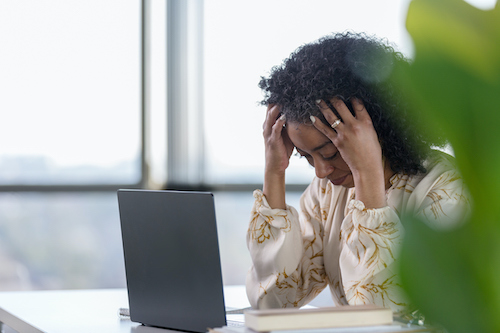 A woman at work who is not feeling well