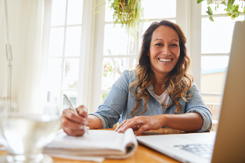 A woman taking notes about the best natural menopause supplements.