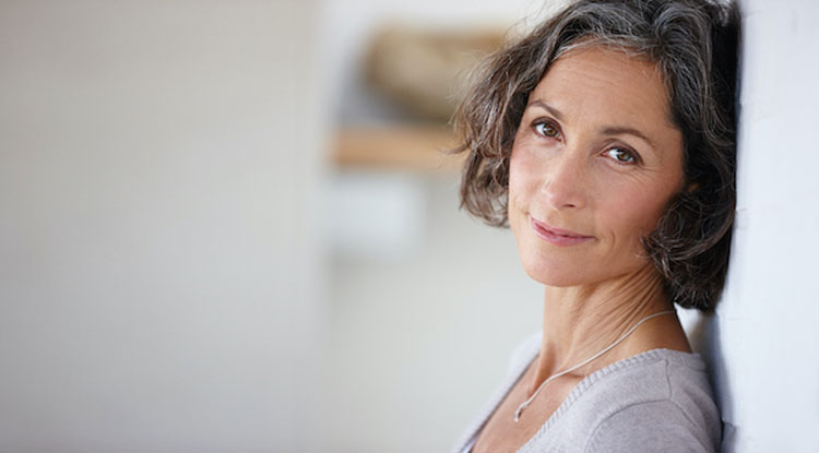 woman leaning against a wall