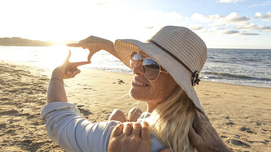 POV Of Woman Relaxing On Sandy Beach, In The Sun