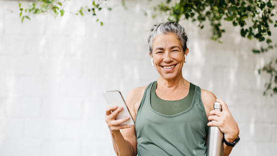 Motivated Senior Woman Browsing Some Music For Her Outdoor Workout Routine