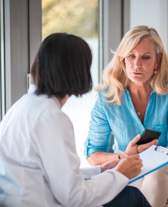 Woman Talking To Doctor About Menopause